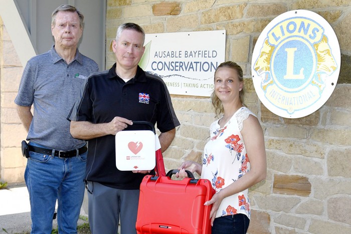 A photo of donation of two life-saving AED machines from Dave Mounsey Memorial Fund.